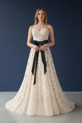 Ivory tulle gown with black bow detail front view