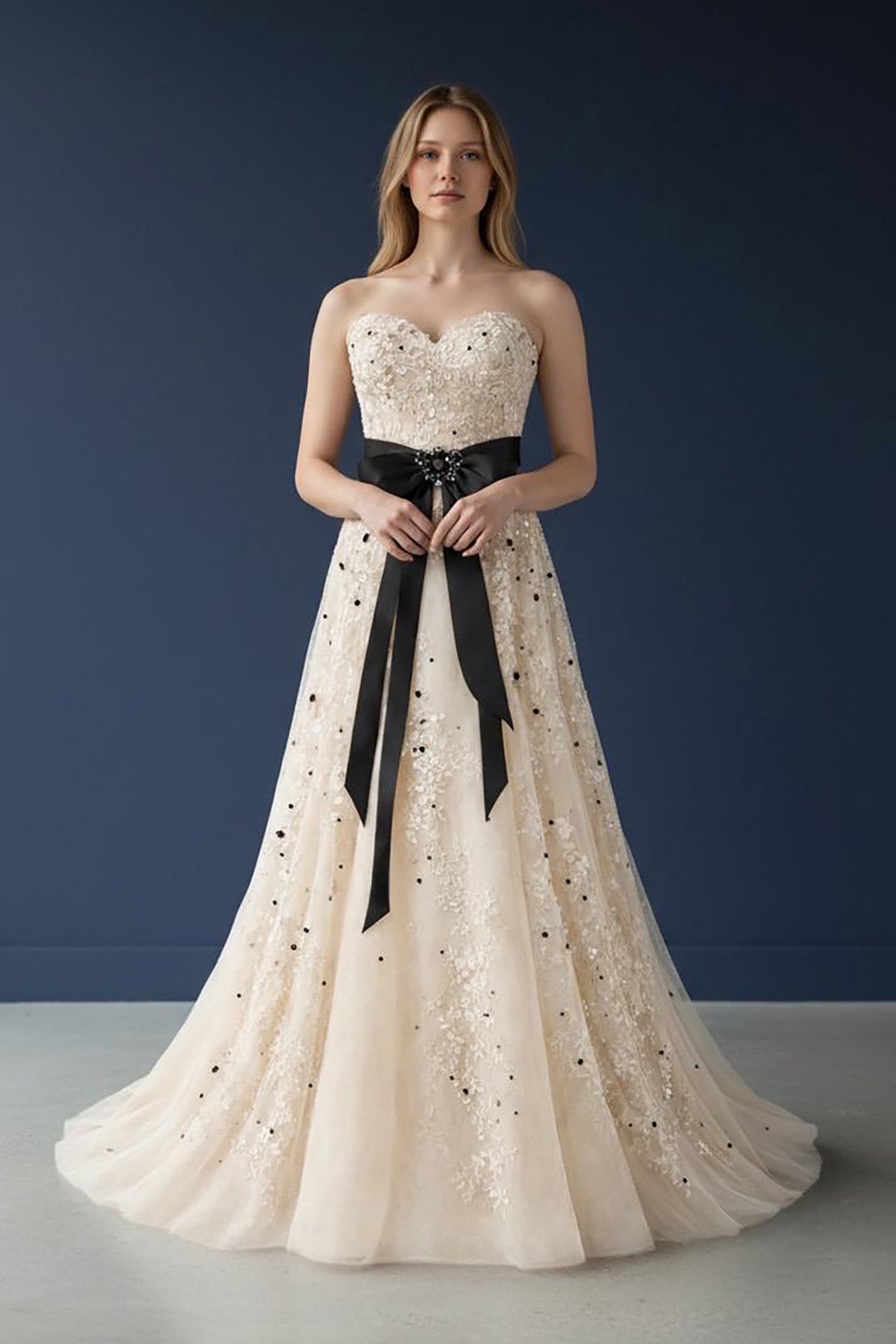 Ivory tulle gown with black bow detail front view